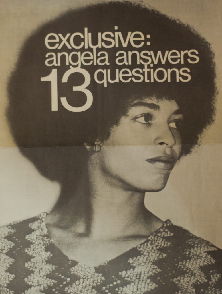 Angela Davis wears a chevron-pattern shirt. The text "exclusive: angela answers 13 questions" is written over her Afro.